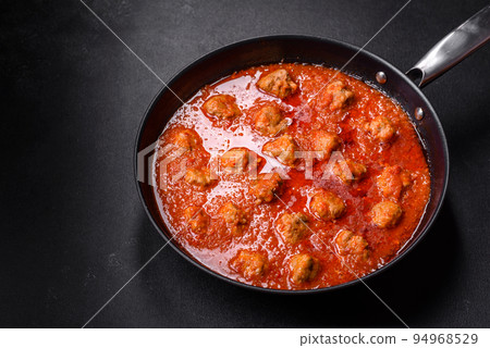 Delicious meatballs made from ground beef in a spicy tomato sauce Delicious meatballs made from ground beef in a spicy tomato sauce 94968529