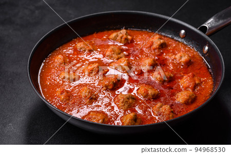 Delicious meatballs made from ground beef in a spicy tomato sauce 94968530