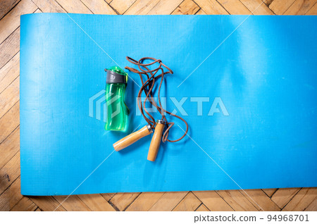Jump rope and bottle of water. Fitness mat. Get yourself into a sporty physical condition. Top. Jump rope and bottle of water. Fitness mat. Get yourself into a sporty physical condition. Top. 94968701