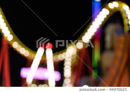 blurred bokeh silhouette of illuminated fun park blurred bokeh silhouette of illuminated fun park 94970025