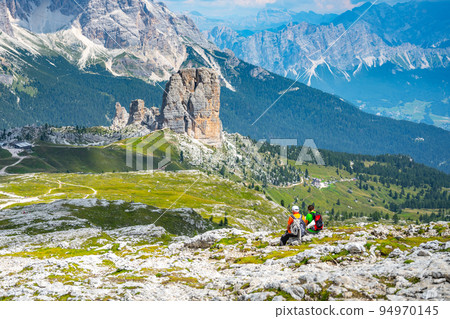 Hikers at Cinque Torri in Dolomites Hikers at Cinque Torri in Dolomites 94970145
