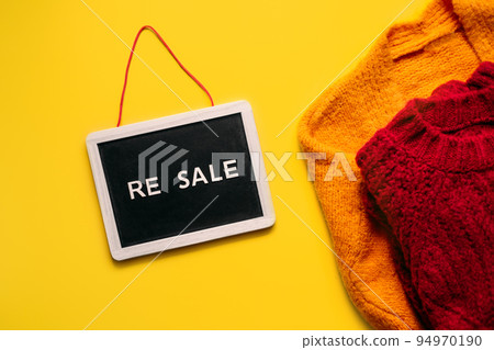 Resale-commerce, re-commerce, re sale concept. Buyback, Trade-In, and Upcycling in Retail. Circular economy. Word resale and clothing on yellow background 94970190