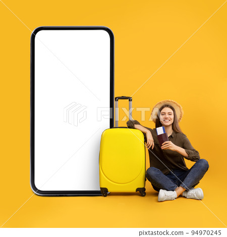 Female Sitting Near Large Smartphone With Blank Screen, Yellow Background 94970245