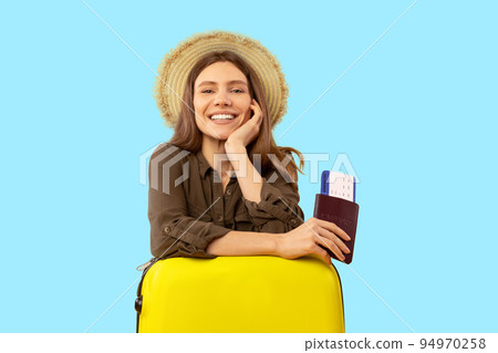 Cheerful Tourist Lady Posing Holding Travel Tickets Over Blue Background Cheerful Tourist Lady Posing Holding Travel Tickets Over Blue Background 94970258