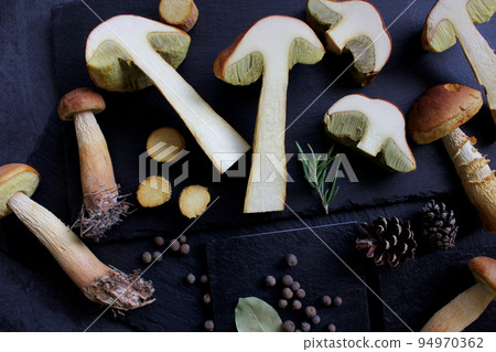 Aureoboletus projectellus mushrooms with spices on dark background. Menu concept. Aureoboletus projectellus mushrooms with spices on dark background. Menu concept. 94970362