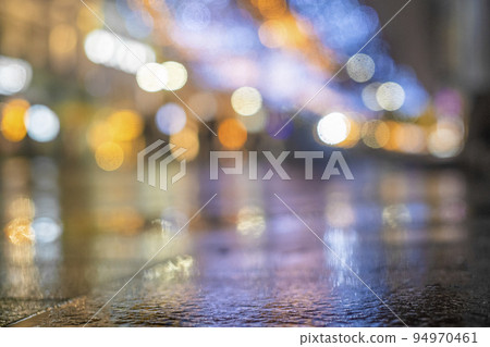 Night urban landscape, colored lights reflected in the wet asphalt in fall. Rainy night street in the city. The lights of a rainy night in the autumn city of disfocus and bokeh. Night urban landscape, colored lights reflected in the wet asphalt in fall. Rainy night street in the city. The lights of a rainy night in the autumn city of disfocus and bokeh. 94970461