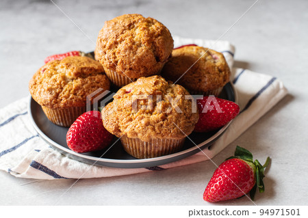Strawberry muffins served in a plate on a marble background. Close up. Strawberry muffins served in a plate on a marble background. Close up. 94971501