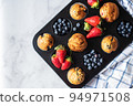 Blueberry and strawberry muffins with berries. Top view and copy space. 94971508