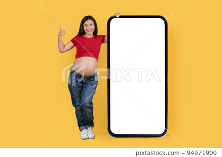 Great Offer. Pregnant Female Standing Near Blank Smartphone And Showing Thumb Up 94971900