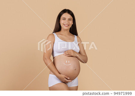 Happy Pregnant Woman With Smile Face Made Of Cream On Her Belly 94971999