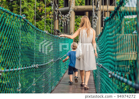 Mother and son at the Suspension bridge in Kuala Lumpur, Malaysia 94974272