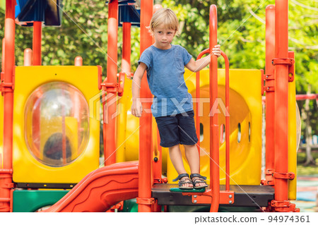 Funny cute happy baby playing on the playground. The emotion of happiness, fun, joy 94974361