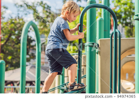Funny cute happy baby playing on the playground. The emotion of happiness, fun, joy Funny cute happy baby playing on the playground. The emotion of happiness, fun, joy 94974365