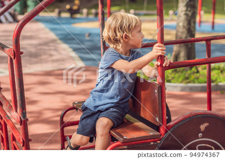Funny cute happy baby playing on the playground. The emotion of happiness, fun, joy 94974367