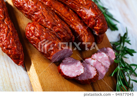 Roasted chezh sausages susena on cutting board Roasted chezh sausages susena on cutting board 94977045