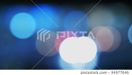 Image of defocussed bokeh traffic and street lights on a city street at night Image of defocussed bokeh traffic and street lights on a city street at night 94977646