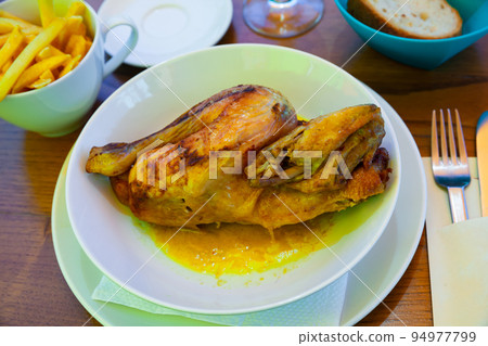 Baked chicken half with sauce. Swiss cuisine 94977799