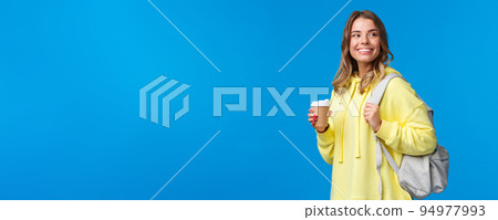 Lifestyle, college and people concept. Good-looking carefree blond woman going university look around happy and pleased smiling as drinking take-away coffee and holding backpack Lifestyle, college and people concept. Good-looking carefree blond woman going university look around happy and pleased smiling as drinking take-away coffee and holding backpack 94977993