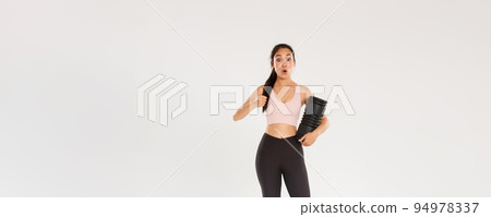 Full length of impressed and satisfied asian female athlete, fitness girl in activewear showing thumbs-up and say wow, tried new foam roller after workout to reduce soreness, white background Full length of impressed and satisfied asian female athlete, fitness girl in activewear showing thumbs-up and say wow, tried new foam roller after workout to reduce soreness, white background 94978337
