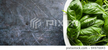 Fresh spinach leaves in a bowl, green vegetables, rustic style, healthy lifestyle, proper nutrition. Top view, space for text, banner Fresh spinach leaves in a bowl, green vegetables, rustic style, healthy lifestyle, proper nutrition. Top view, space for text, banner 94978843