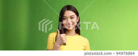 Close-up happy motivated good-looking asian woman give thumb-up smiling, approving excellent effort, like good choice, accept terms, recommend product, like idea, green background Close-up happy motivated good-looking asian woman give thumb-up smiling, approving excellent effort, like good choice, accept terms, recommend product, like idea, green background 94978864