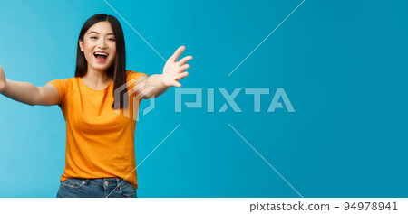 Come closer let me hug you. Cheerful lovely asian brunette girl stretch hands forward wanna cuddle, embracing friend smiling broadly inviting dear guests welcoming, stand blue background Come closer let me hug you. Cheerful lovely asian brunette girl stretch hands forward wanna cuddle, embracing friend smiling broadly inviting dear guests welcoming, stand blue background 94978941