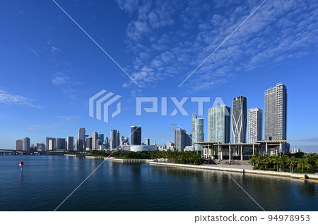 City of Miami, Florida reflected in calm water of Biscayne Bay on sunny morning. City of Miami, Florida reflected in calm water of Biscayne Bay on sunny morning. 94978953