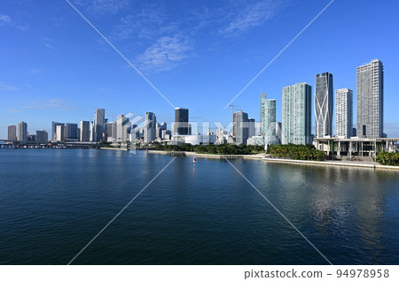 City of Miami, Florida reflected in calm water of Biscayne Bay on sunny morning. City of Miami, Florida reflected in calm water of Biscayne Bay on sunny morning. 94978958