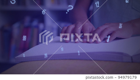 Digital composition of numbers and symbols floating against mid section of boy reading a book in bra Digital composition of numbers and symbols floating against mid section of boy reading a book in bra 94979179