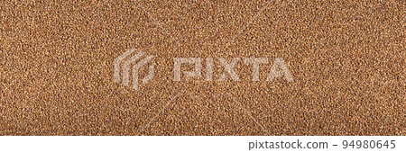 Texture of buckwheat. Background for dry buckwheat design. Large size for banner printing or packaging. Top view of evenly scattered buckwheat groats. Texture of buckwheat. Background for dry buckwheat design. Large size for banner printing or packaging. Top view of evenly scattered buckwheat groats. 94980645