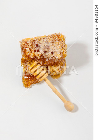 sliced honeycomb and honey dipper stick sliced honeycomb and honey dipper stick 94981154