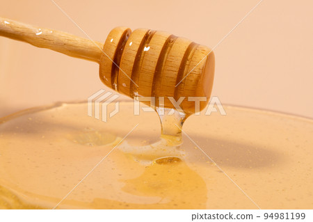 honey dipper stick and honey texture 94981199