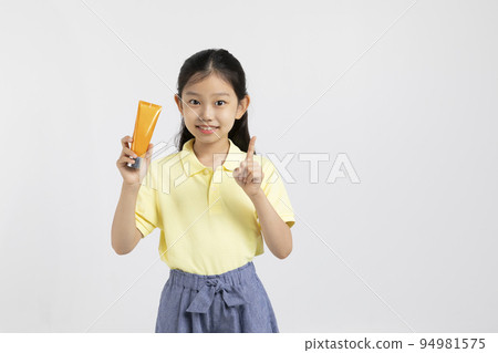 Korean young girl wearing gym clothes in white background studio__holding sunscreen, sunblock Korean young girl wearing gym clothes in white background studio__holding sunscreen, sunblock 94981575