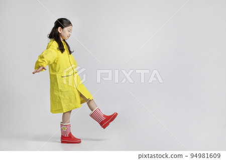 cute young Korean girl, rainy season concept in white background studio__walking forward in a raincoat cute young Korean girl, rainy season concept in white background studio__walking forward in a raincoat 94981609