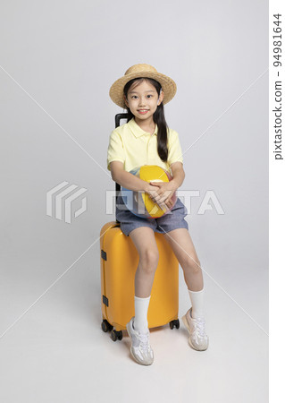 Korean young girl wearing gym clothes in white background studio__holding a beach ball sitting on the career Korean young girl wearing gym clothes in white background studio__holding a beach ball sitting on the career 94981644