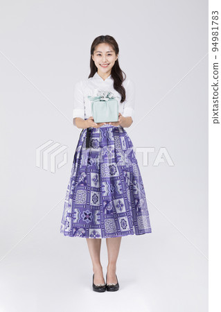 beautiful Korean woman in 20s wearing modern Hanbok_holding gift box beautiful Korean woman in 20s wearing modern Hanbok_holding gift box 94981783