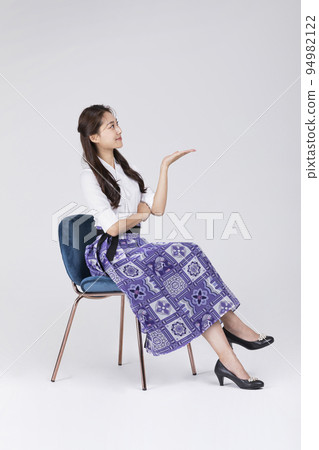 beautiful Korean woman in 20s wearing modern Hanbok_guiding hand motion beautiful Korean woman in 20s wearing modern Hanbok_guiding hand motion 94982122