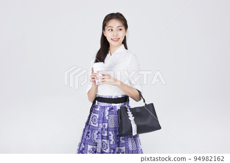 beautiful Korean woman in 20s wearing modern Hanbok_holidng a tumbler beautiful Korean woman in 20s wearing modern Hanbok_holidng a tumbler 94982162