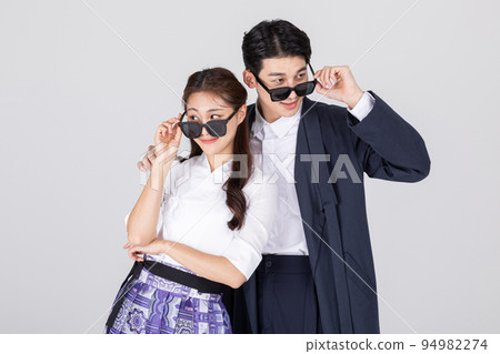 Korean young couple, man and woman wearing modern Hanbok_playing with sunglasses on 94982274
