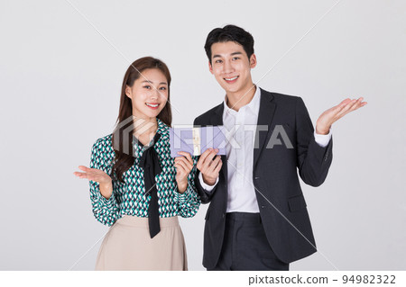 Korean young couple, man and woman wearing modern Hanbok_holding Korean traditional wedding clutch, envelope 94982322