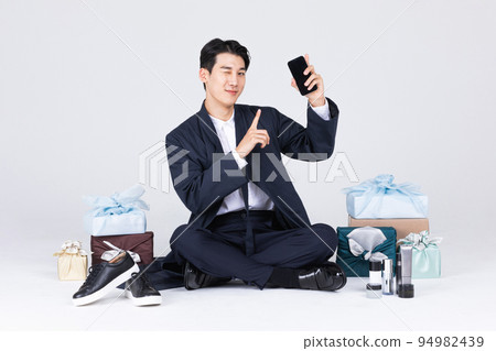 goodlooking Korean young man in 20s wearing modern Hanbok wearing hanbok_sitting man with traditional box and man's cosmetic and shoes goodlooking Korean young man in 20s wearing modern Hanbok wearing hanbok_sitting man with traditional box and man's cosmetic and shoes 94982439