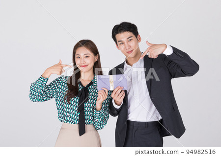Korean young couple, man and woman wearing modern Hanbok_holding Korean traditional wedding clutch, envelope 94982516