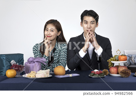 Korean young couple, man and woman wearing modern Hanbok_looking forward with smiling Korean young couple, man and woman wearing modern Hanbok_looking forward with smiling 94982566
