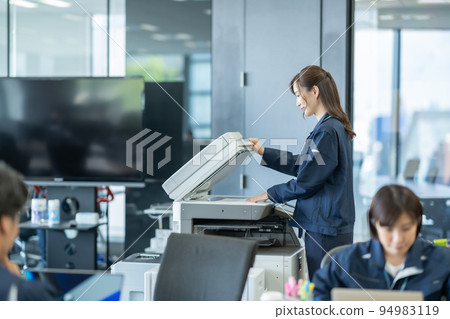 A woman who scans A4 paper and converts it into data A woman who scans A4 paper and converts it into data 94983119