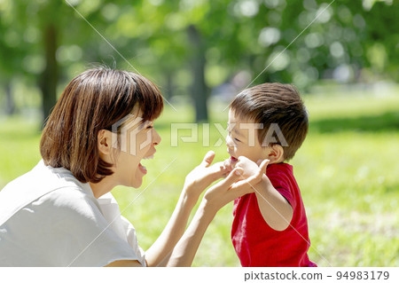 Mother and son playing in early summer park Mother and son playing in early summer park 94983179