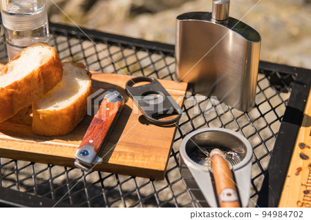 Enjoying cigars outdoors 94984702