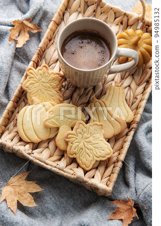 Cup of coffee, cookies on tray, yellow leaves. Cup of coffee, cookies on tray, yellow leaves. 94985132
