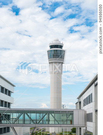 Air traffic control tower that controls the traffic of airplanes Air traffic control tower that controls the traffic of airplanes 94986080