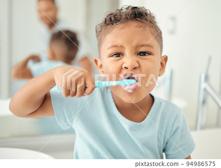 Portrait of learning child cleaning and brushing teeth in home bathroom for dental care, tooth care or oral health. Morning routine, child development and life skill education for kid with toothbrush Portrait of learning child cleaning and brushing teeth in home bathroom for dental care, tooth care or oral health. Morning routine, child development and life skill education for kid with toothbrush 94986575