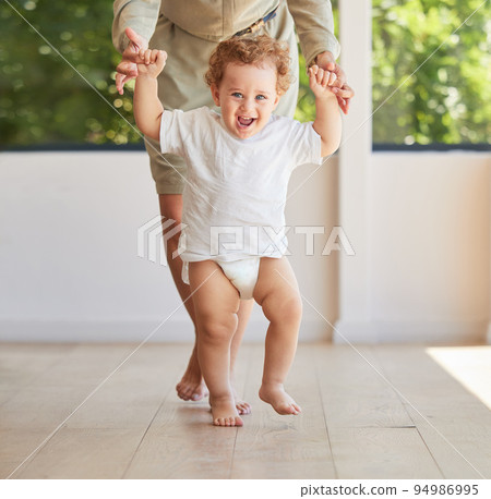 Development, walking and baby learning with mother helping support her childs growth, progress and first steps. Smile, happy and parent holding hands with her kid teaching her excited son to stand Development, walking and baby learning with mother helping support her childs growth, progress and first steps. Smile, happy and parent holding hands with her kid teaching her excited son to stand 94986995